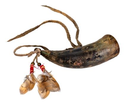Old powder horn of the North American Indians made of horn decorated with deerskin and feathers isolated on white