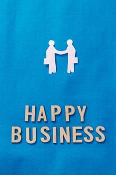 Two Businessman shaking hands on Blue background. Origami Papercraft decorative shapes and figures. Happy Business. Vertical.