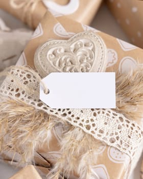 Valentines present with horizontal gift tag, heart and pampas grass close up. Spring scene with blank label. Rustic, cottage chic or bohemian mockup, copy space