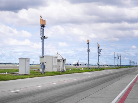 The planes are parked at the airport, close to the road and pold