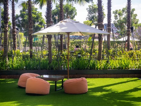 Many colorful bean bag seats to relax on grass outdoors. A convenient place to relax, a company or for one.