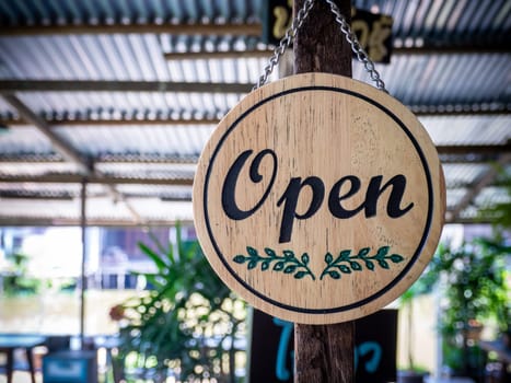 Wooden open sign or symbol with word retro cafe. Concept for opening the shop or cafe in the morning.