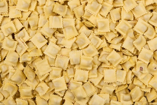 tasted italian food. Quantity of ravioli pasta as a background. Top view style