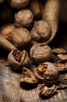Cracked walnuts on rustic wooden table