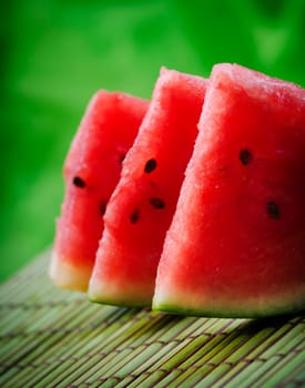 Watermelon slices on green background