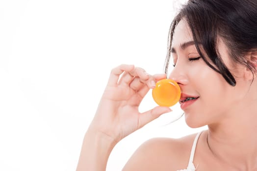 Asian young beautiful woman smiling she's holding orange handcrafted organic soap skin care near face for present product isolated on over white background, Beauty Zero waste concept