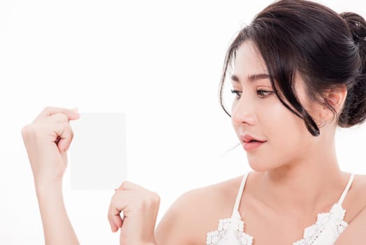 Asian young beautiful woman smiling she's holding blank square skin care near face for present product isolated on over white background, Beauty concept