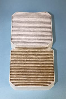 Two small square air filters that are also pre-filters, one dirty closer to viewer and one clean on a light blue background. One dirty air filter filled with dust, allergens and dirt under a clean one