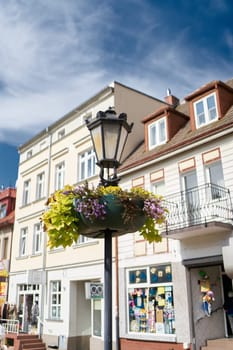 Lantern with flowers as decoration in downtown Kolobrzeg in Poland