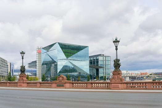 The Cube Berlin office building on Washingtonplatz, with the main train station in Berlin behind it