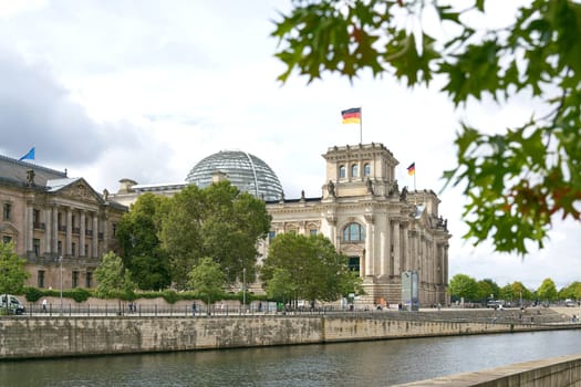 The Reichstag in Berlin on the banks of the Spree River. The Reichstag is the seat of the German Bundestag.