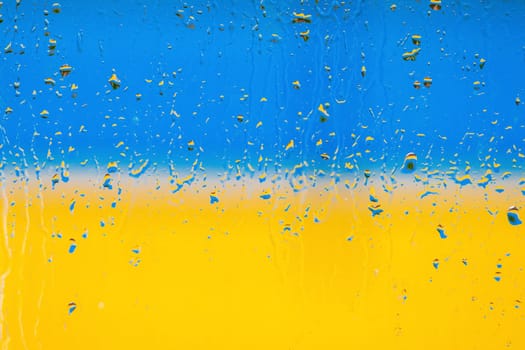Flag of Ukraine. Abstraction. Raindrops on glass