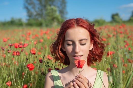 girl with poppy flower in poppy field