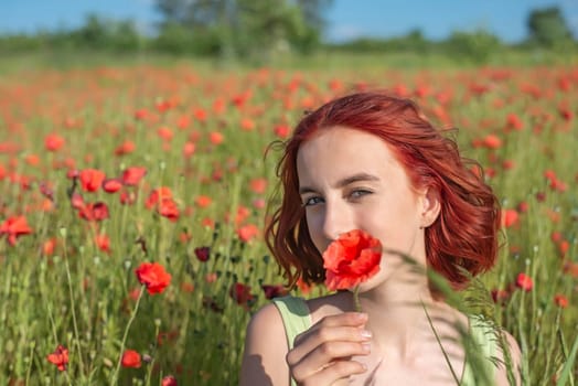 girl with poppy flower in poppy field