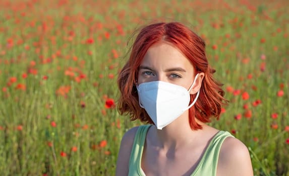 frustrated young girl with protective mask in poppy field