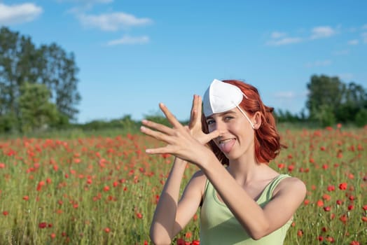 girl with mask on her head sticks her tongue out