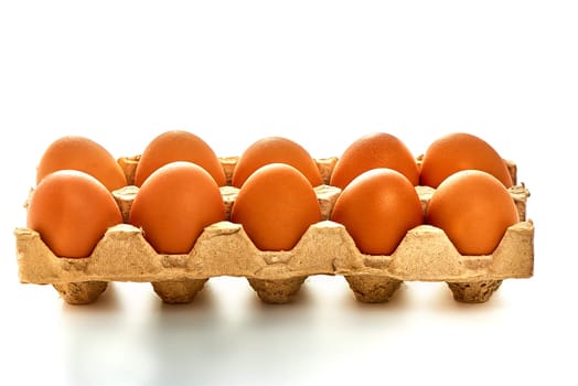 A dozen white eggs on a cardboard stand on a white isolated background. High quality photo