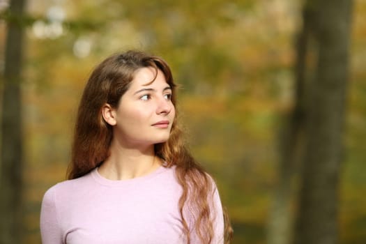 Serious woman looking at side walking in a park