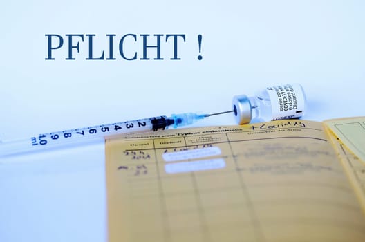 Will the corona vaccination become mandatory. Corona Covid-19 Vaccination with Vaccination Card, Syringe and Vaccine Bottle
