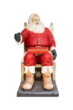 Front view closeup of colored Santa Claus Christmas statue waiting for children to sit and make a wish isolated on white background