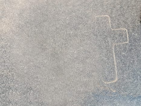 The outline of a cross on marble. A symbol of Christianity on gray marble. The main symbol of Christianity.