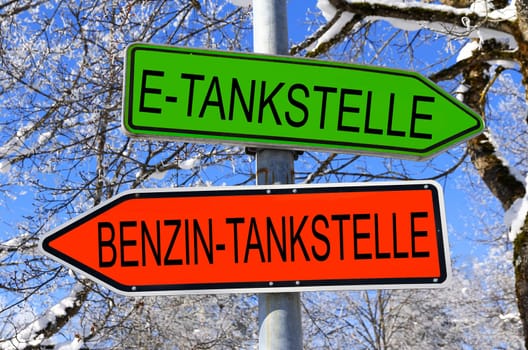 Signs in green for the e-filling station and in red for the gasoline filling station