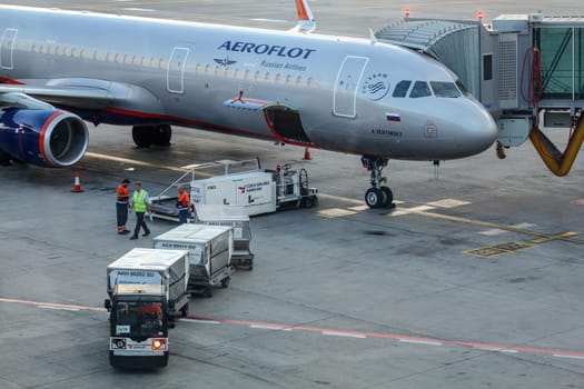 Prague, Czech Republic - July 28th, 2018: Ground personnel loading baggage cargo into Aeroflot Airbus A321 aircraft on Ruzyne, Vaclav Havel Airport. Flights to Russia are operated daily from Czechia.