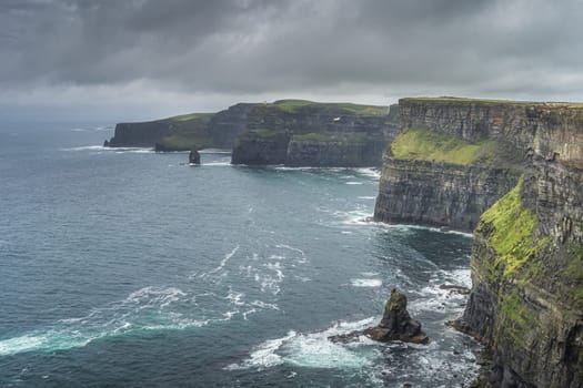 Beautiful and tall, iconic Cliffs of Moher with turquoise waters of Atlantic Ocean, popular tourist attraction, Wild Atlantic Way, Co. Clare, Ireland