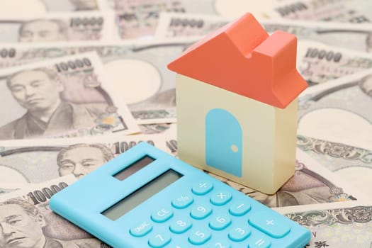 small toy house on Japanese ten thousand yen bills banknotes