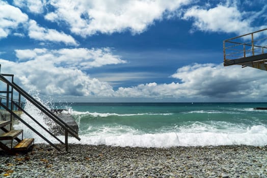 The sea is stormy. Large waves break on the breakwater .Crimea