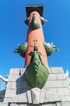 The statue at the foot of the Rostral Column. The arrow of Vasilievsky Island. Saint-Petersburg. Russia