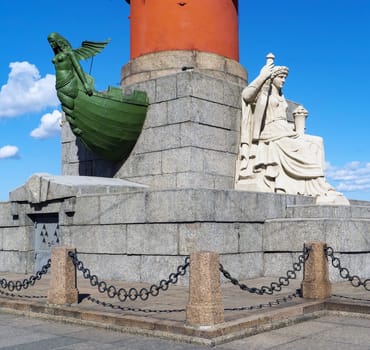 The statue at the foot of the Rostral Column. The arrow of Vasilievsky Island. Saint-Petersburg. Russia