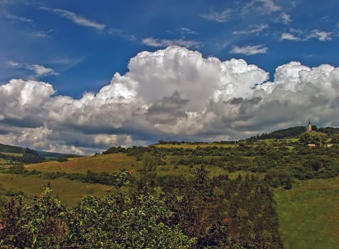 Church on hill with clouds