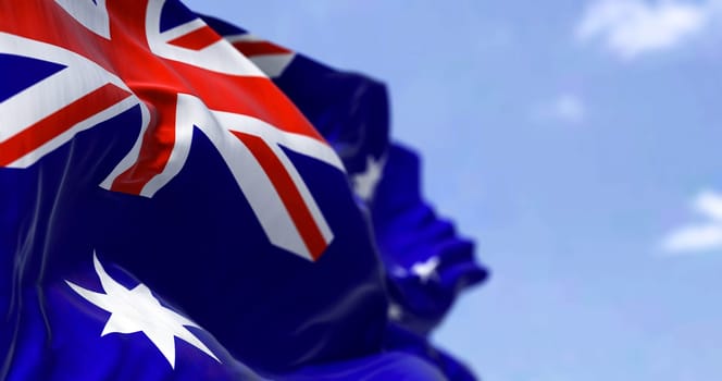 Detailed close up of the national flag of Australia waving in the wind on a clear day. Democracy and politics. Australian continent. Selective focus.