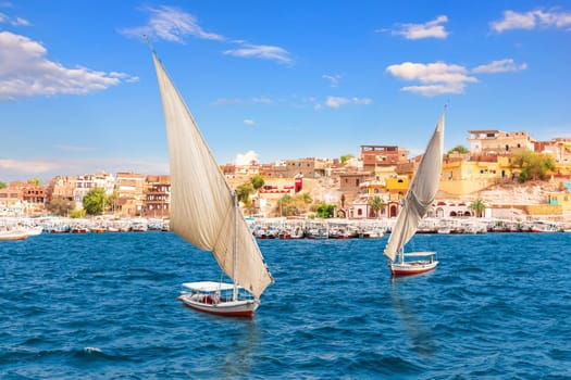 Feluccas on the Nile near egyptian village, Aswan, Egypt.