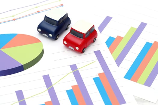 toy car and color chart printed documents on the table
