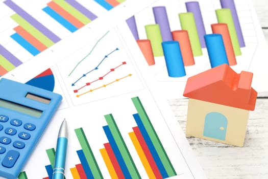 toy house and color chart printed documents on the table