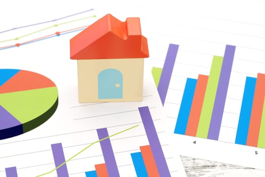 toy house and color chart printed documents on the table