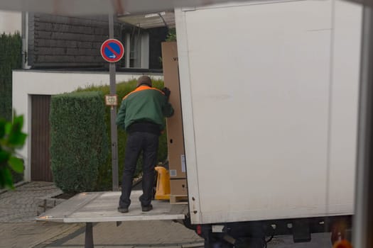 HEILIGENHAUS, NRW - JANUARY 27, 2020:.Logistics and transport of the freight industry, freight shipping, courier transport in the warehouse by truck, stack packaging of packaging boxes that wraps pallet loads in a truck in plastic..