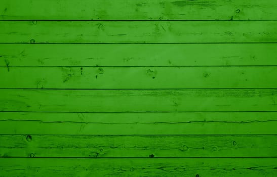 Green wooden wall with weathered planks