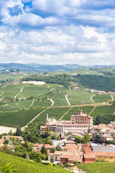 Panoramic countryside in Piedmont region, Italy. Scenic vineyard hill with the famous Barolo Castle and city.