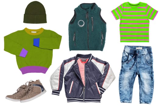 Collage set of little boy autumn clothing isolated on a white background. Denim trousers jeans, a pair sneaker, a rain jacket, a fur vest, a sweater with hood and a shirt for child boy. Kids winter fashion.