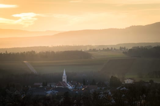 Sunset behind the Village of Ritzing Burgenland with the orange sky