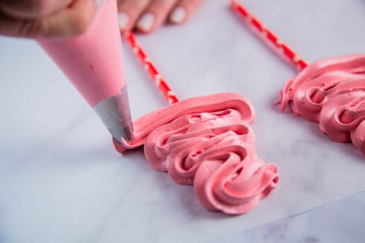 From the pastry bag, a pink bizet is laid out on baking paper with curls in the form of a Christmas tree. High quality photo