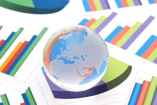 Glass globe of Europe and Africa with graph printed documents