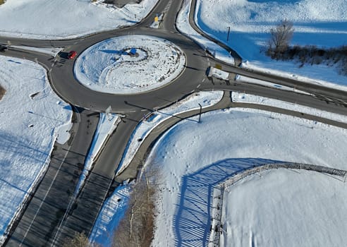 Aerial drone shot of a traffic circle in winter