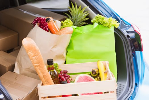 Grocery service giving fresh vegetables and fruits and food in green cloth bag and wooden basket on the back car ready delivery to send woman customer