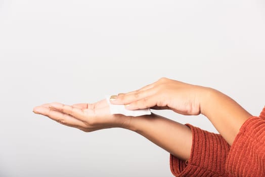 Close up hand of Asian woman she using wet tissue paper wipe cleaning her hands, studio shot isolated on white background, Healthcare medicine body care concept