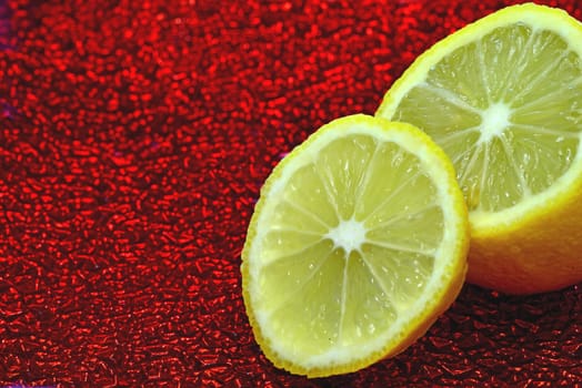 lemon slice on a red shiny enamelled plate