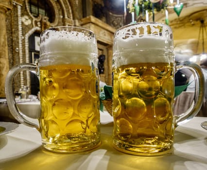Close-up image of two mugs of beer at a restaurant in Munich, Germany